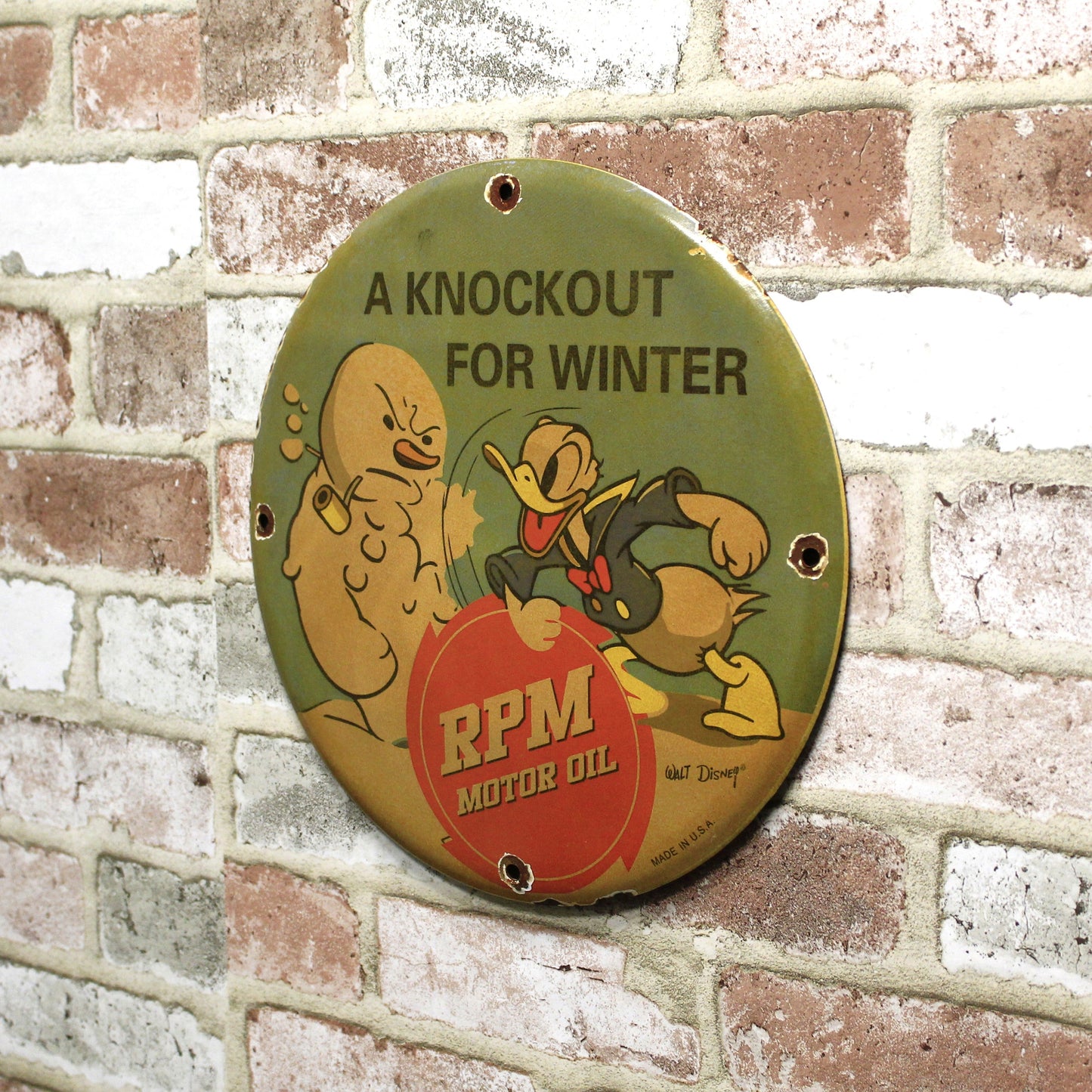RPM Motor Oil Donald Duck Knockout for Winter Porcelain Enamel Sign (12in)