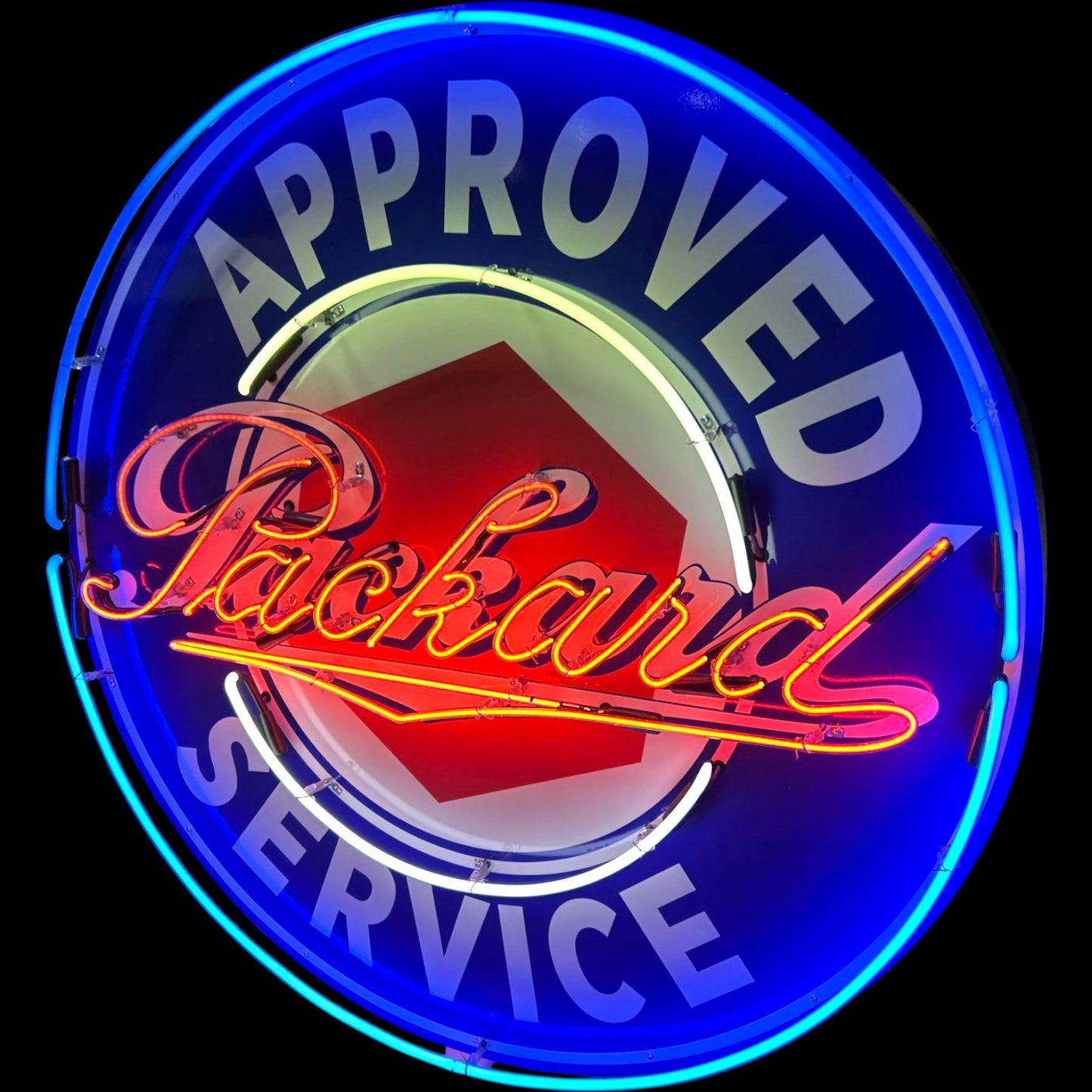 Neon sign with 'Approved Packard Service' text on a black background