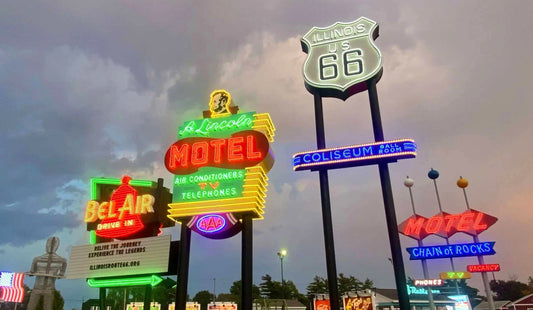 Series of vintage glowing hotel and motel shields and signs at a neon sign park