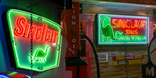 Glowing green dino Sinclair shield chevron neon sign on the left and on the right a Sinclair Oils and Lubricants