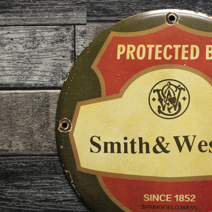 Protected by Smith & Wesson Porcelain Enamel Sign (12in)
