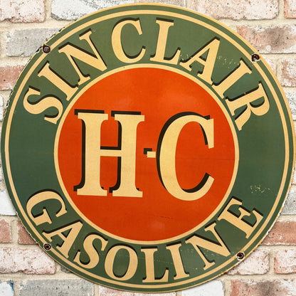 Vintage Sinclair H-C Gasoline sign on a brick wall background