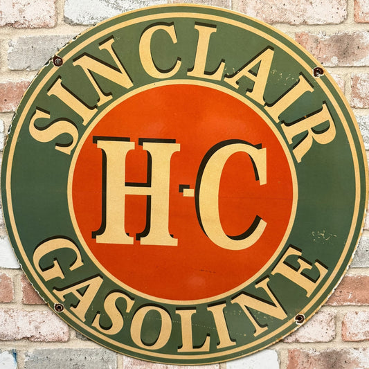 Vintage Sinclair H-C Gasoline sign on a brick wall background