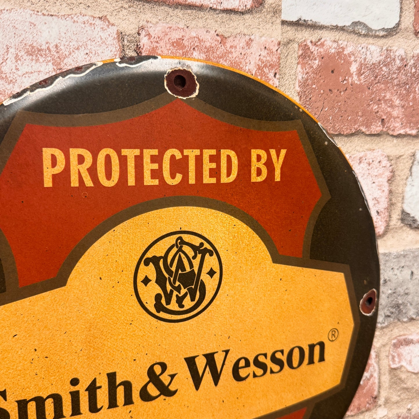 Protected by Smith & Wesson Porcelain Enamel Sign (12in)