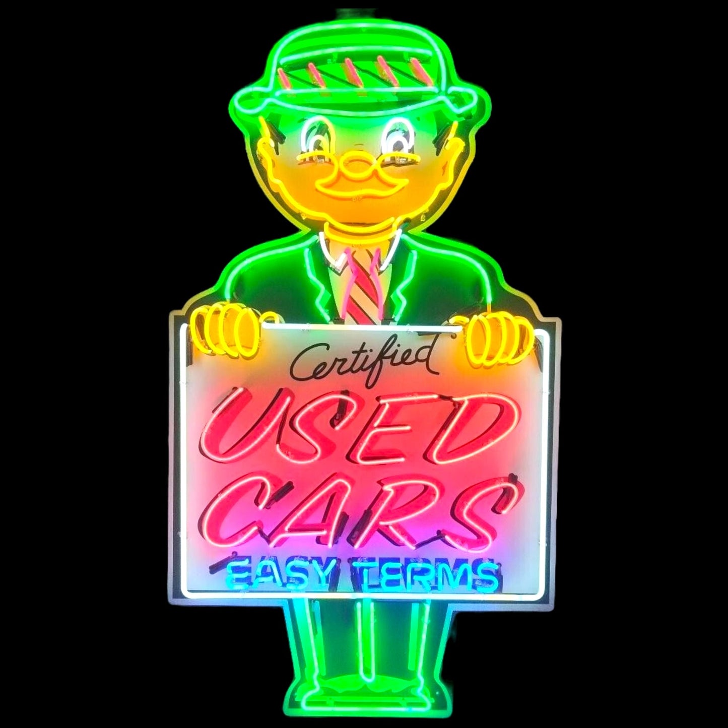 Neon sign of a cartoon character holding a 'Certified Used Cars Easy Terms' sign.