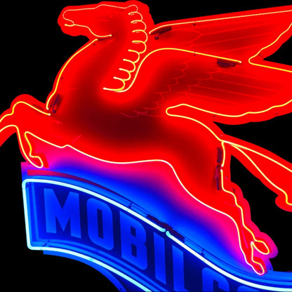 Neon sign of a winged horse with 'Mobil' branding on a black background