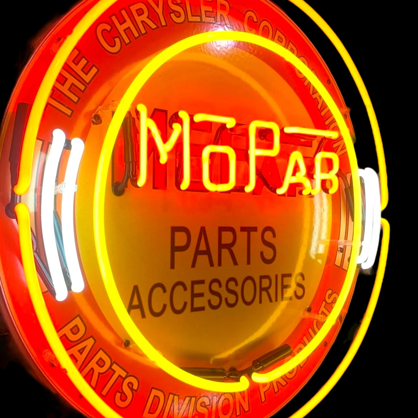 Angled view of Mopar Parts & Accessories neon sign showing porcelain finish and curved white side tubes
