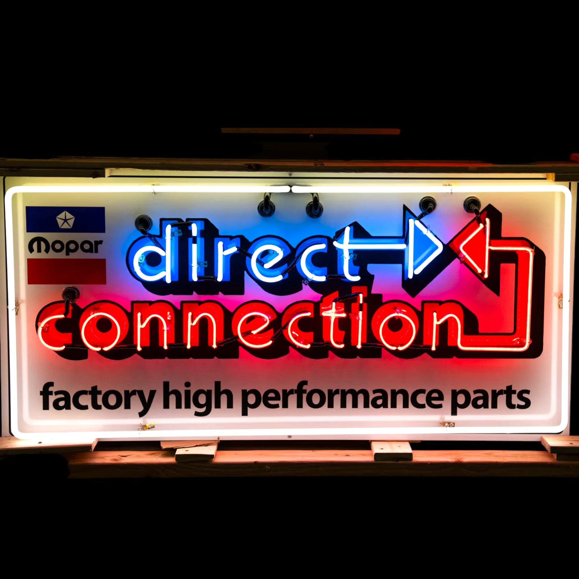 Mopar Direct Connection neon sign with red, white, and blue arrows and “factory high performance parts” text