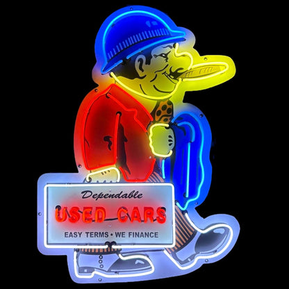 Dependable Used Cars neon porcelain sign with character holding a sign that reads “Dependable Used Cars – Easy Terms • We Finance.”