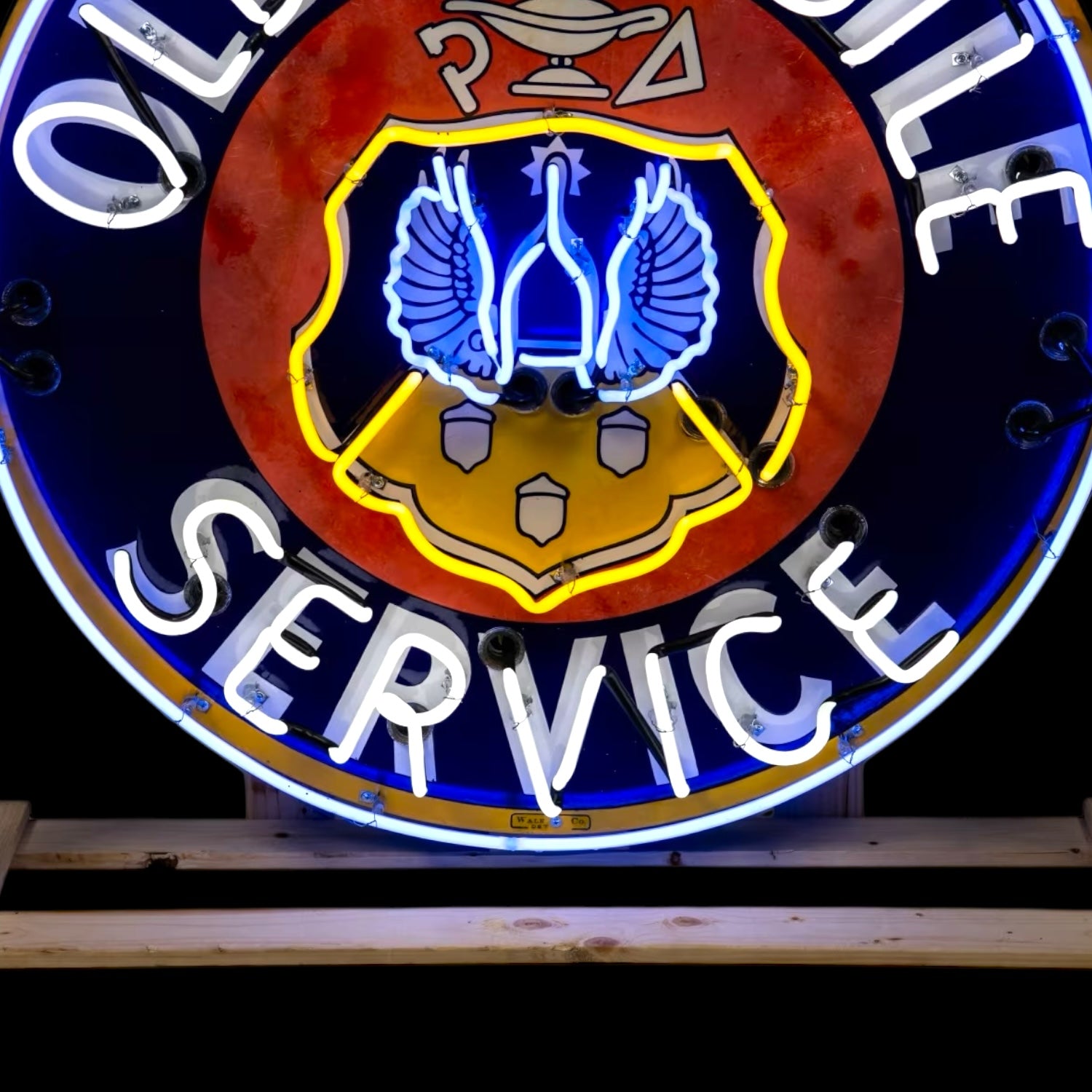 Close up of the service portion and bottom half of neon dealership sign
