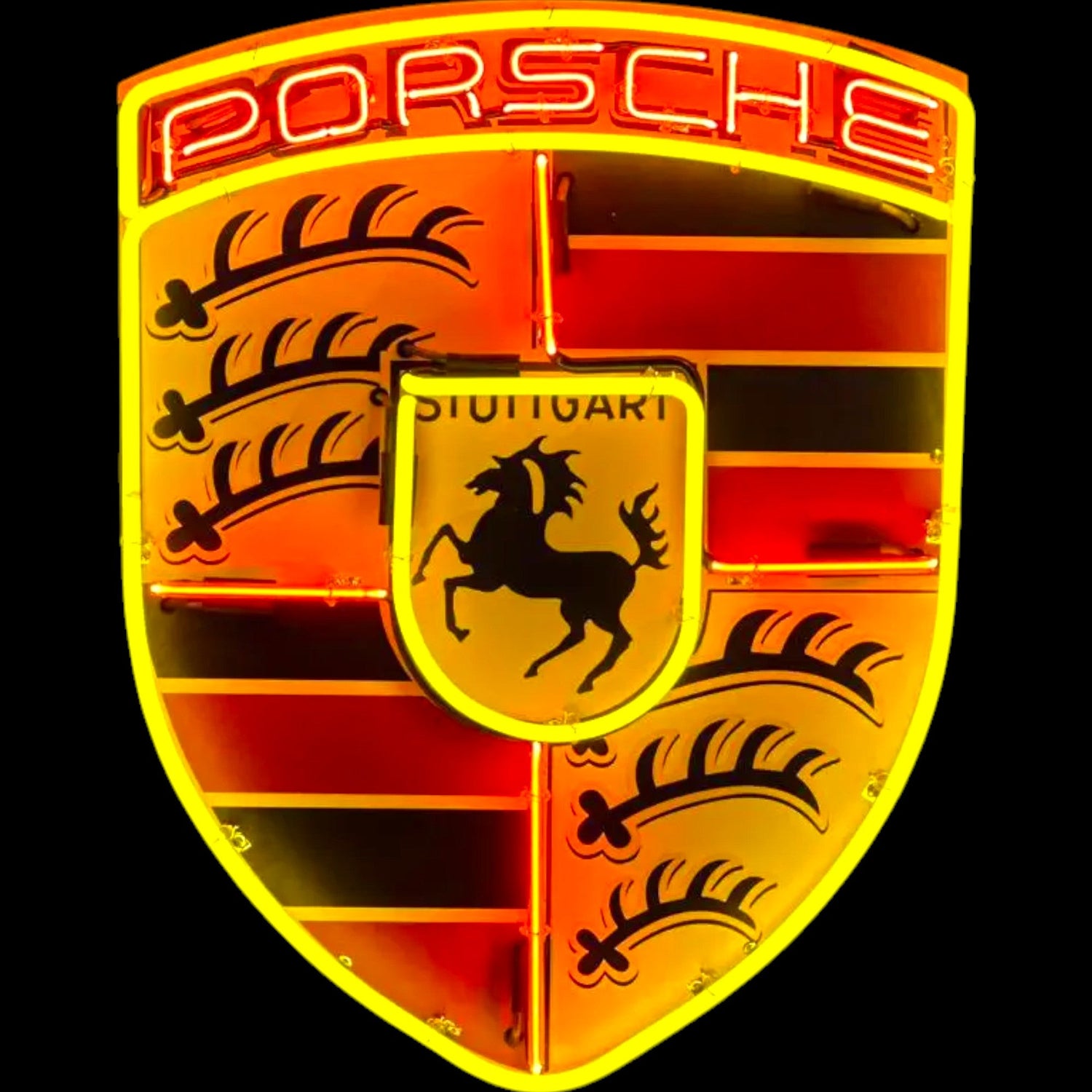 Close-up of a Porsche logo with a red and yellow color scheme on a black background.