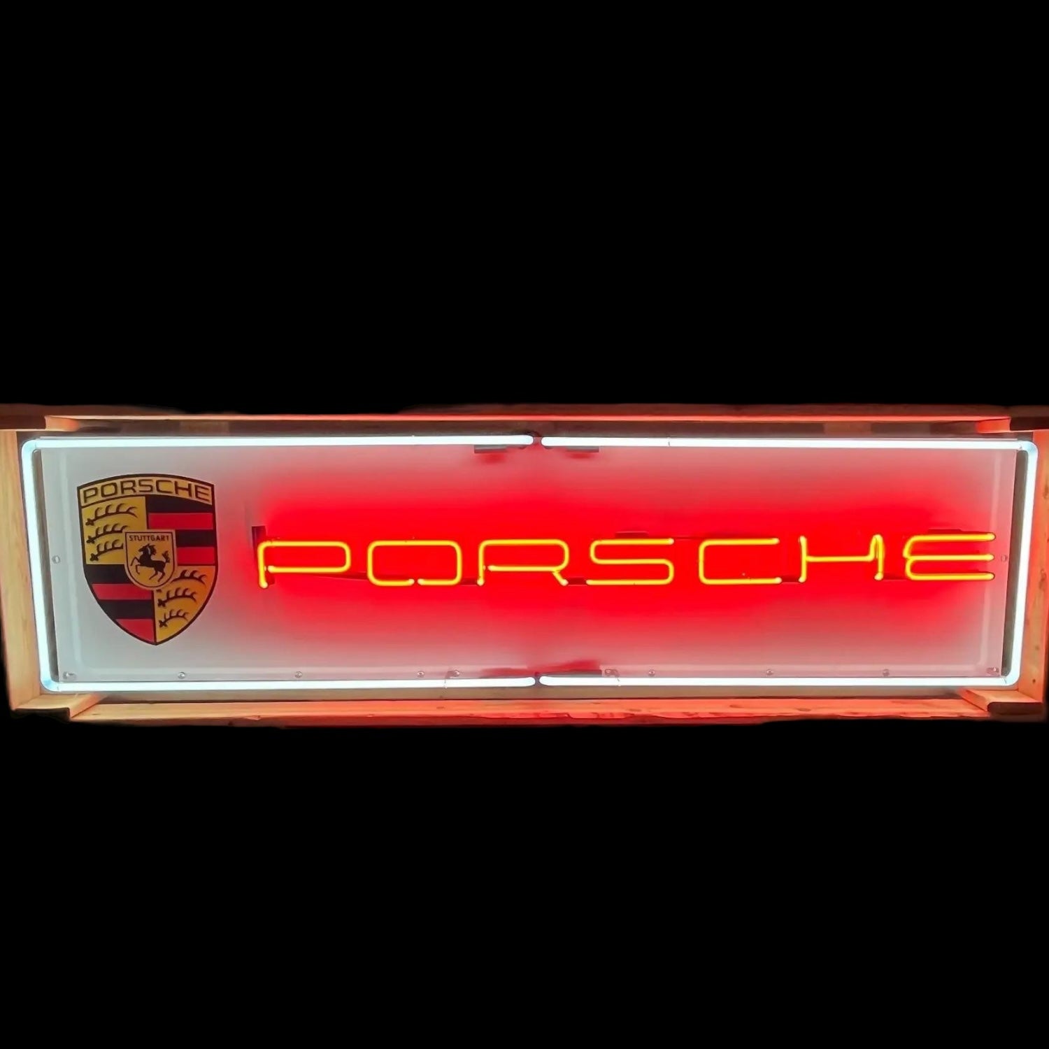 Red Porsche neon panel sign with yellow neon lettering and white border.