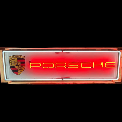 Red Porsche neon panel sign with yellow neon lettering and white border.
