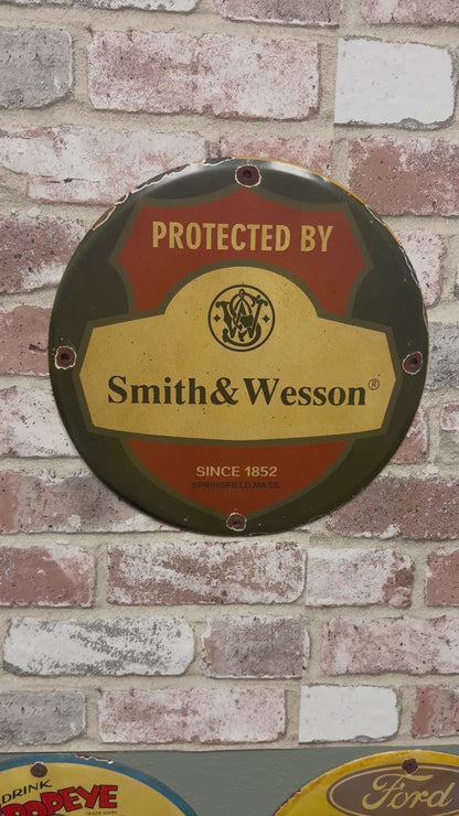 Protected by Smith & Wesson Porcelain Enamel Sign (12in)