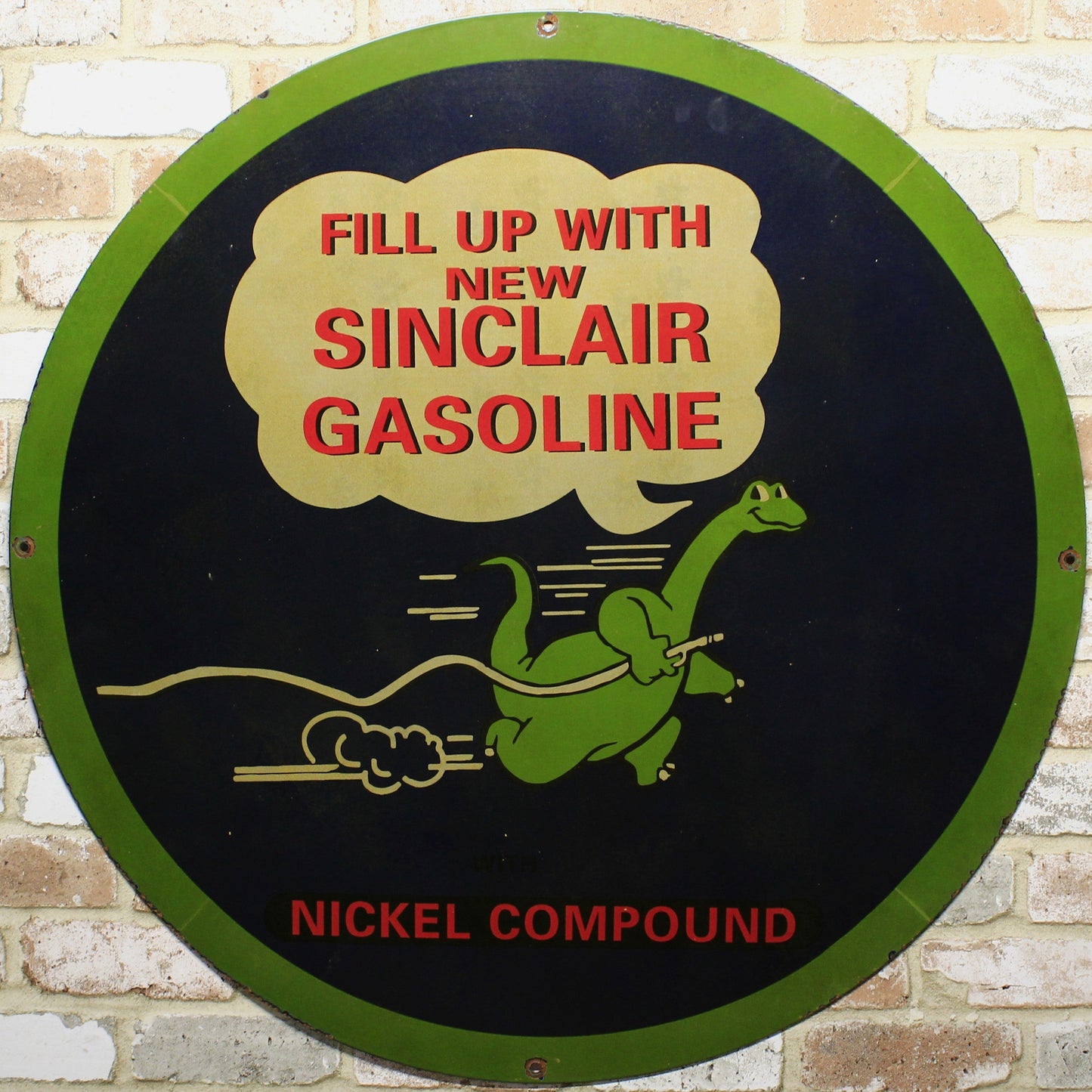 Round sign advertising Sinclair Gasoline with a green dinosaur logo on a brick wall background.